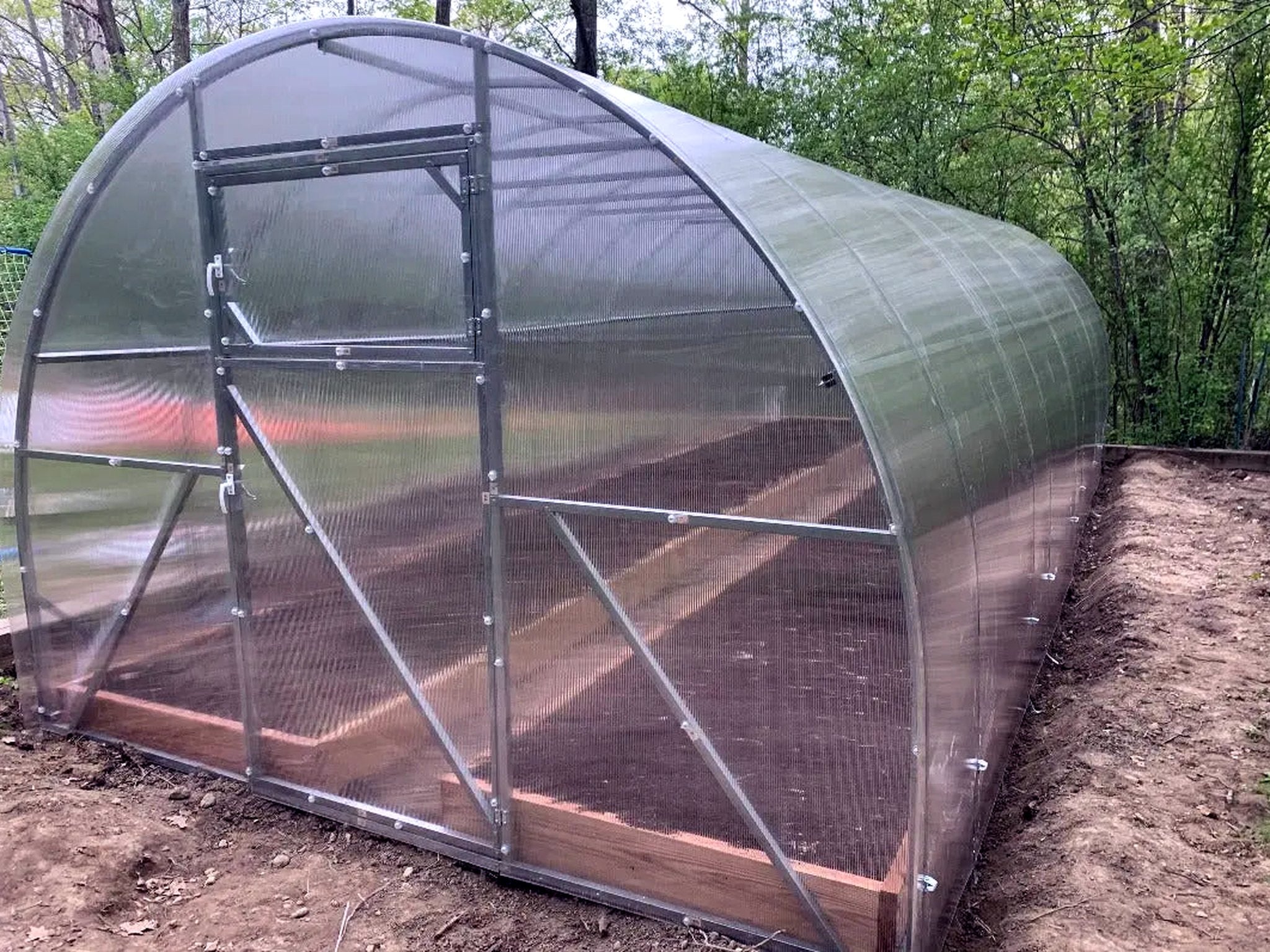 Arc Series end wall with its Dutch door and roof vent on a galvanized steel arch frame